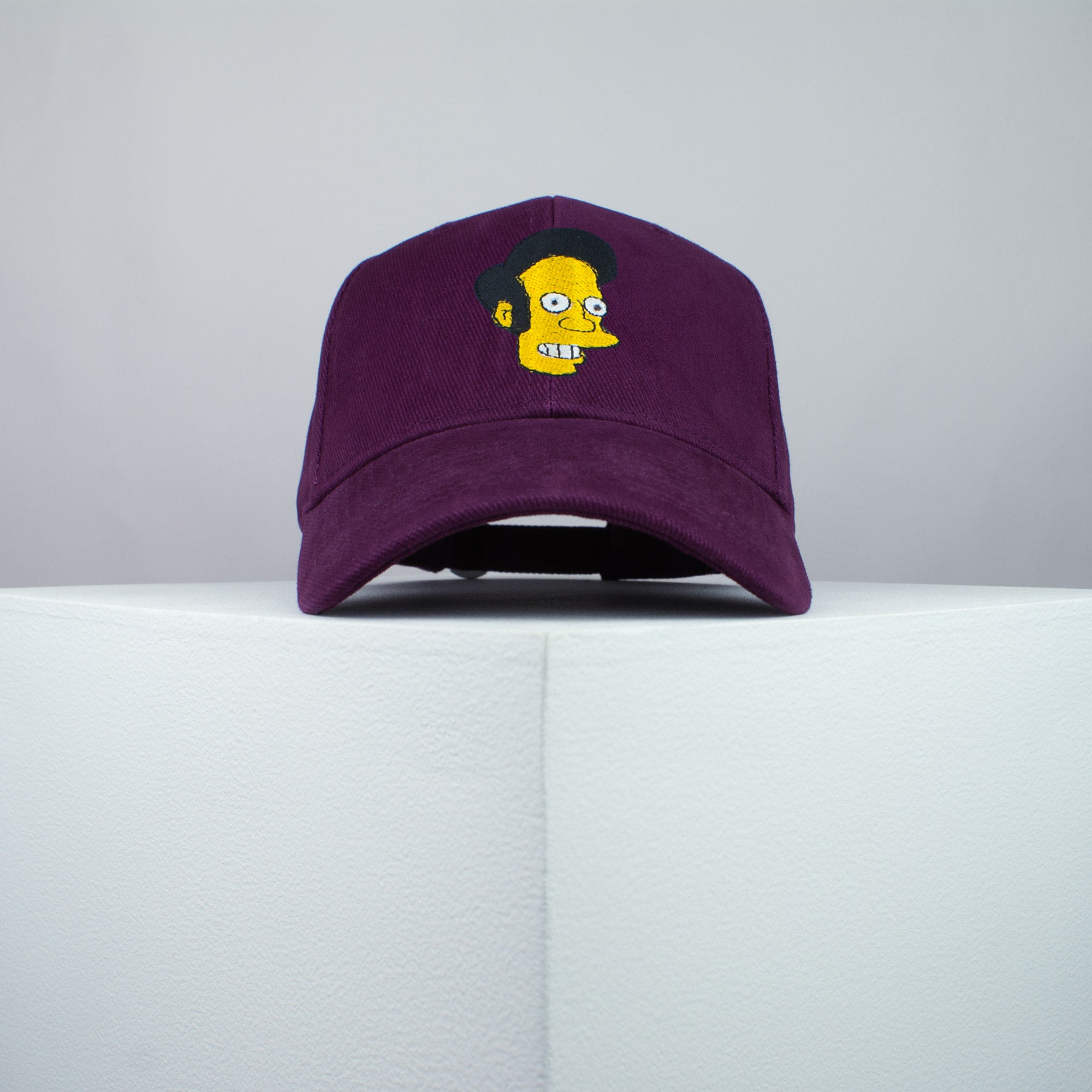 Apu Nahasapeemapetilon embroidered baseball cap burgundy / the simpsons / bart / marge / homer / embroidery / patch / hat / dad hat / cap / iron on patch / embroidered patch / badge / applique / embroidered / punk patches / trucker hat / snapback / caps / dad hats / baseball hat / mens hat / womens hat / embroidered hat / dad cap / embroidered cap